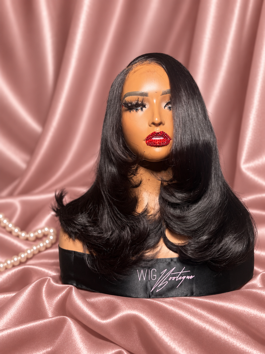 Aaliyah layered blowout wig on rose-champagne satin with ivory pearls