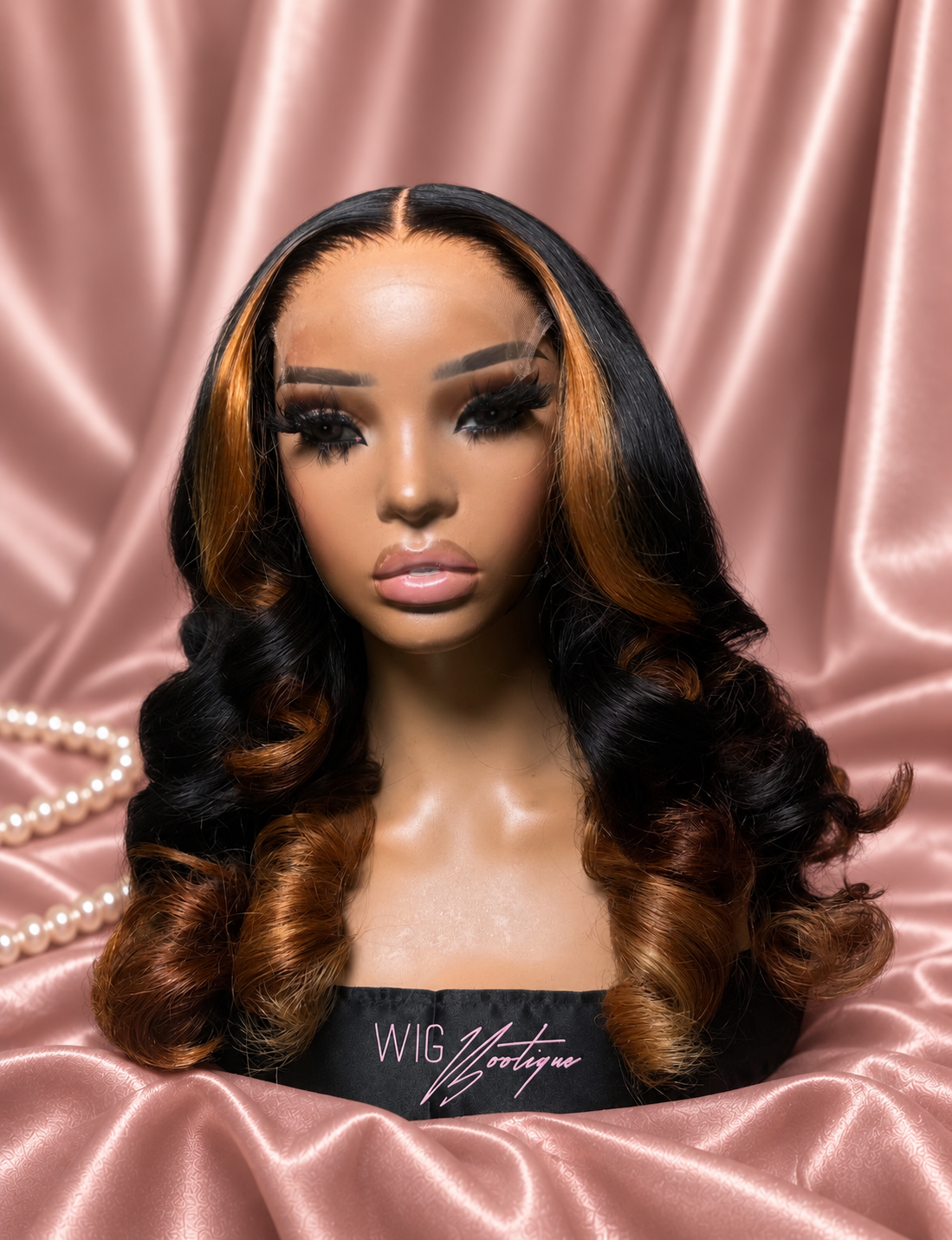 Autumn highlighted curl wig on rose satin, front view