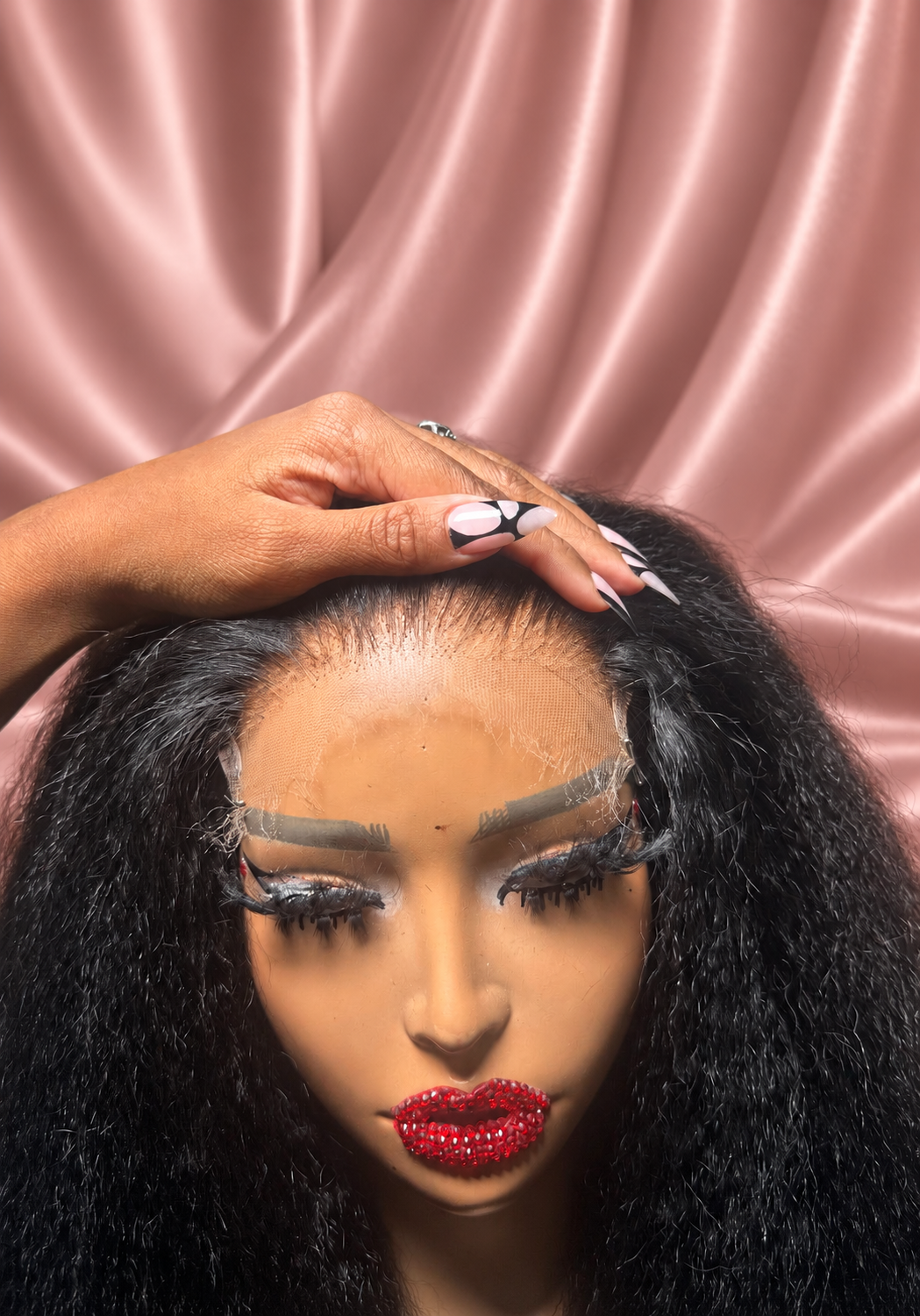 Kinky Straight wig lace and hairline close-up against rose satin