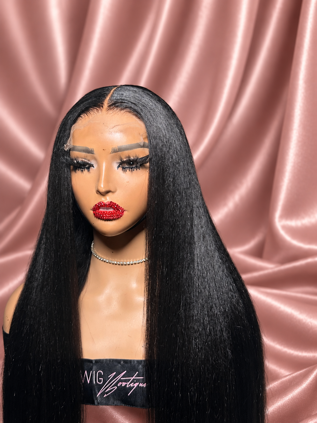 Kinky Straight wig in a pressed style on rose satin, close-up