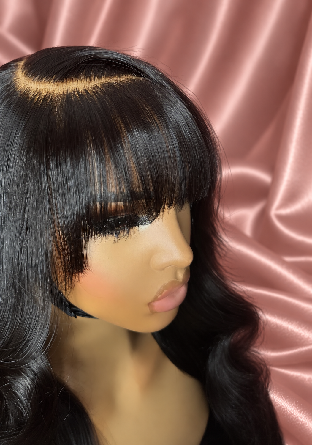 Mecca wig with bangs, close-up 5, against rose-champagne satin